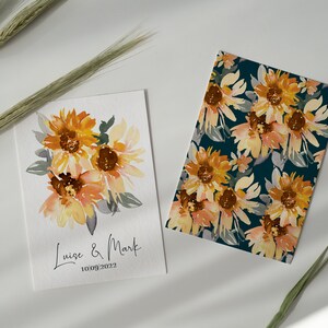 May include: Two cards with watercolor sunflower designs. One card features a bouquet of sunflowers with the names "Luise & Mark" and the date "10/09/2022". The other card has a repeating sunflower pattern on a dark teal background.