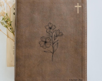 May include: Brown leather journal with a floral design and a gold cross. The journal has a stitched border and the name "Charlotte June". The cover features a debossed floral illustration.