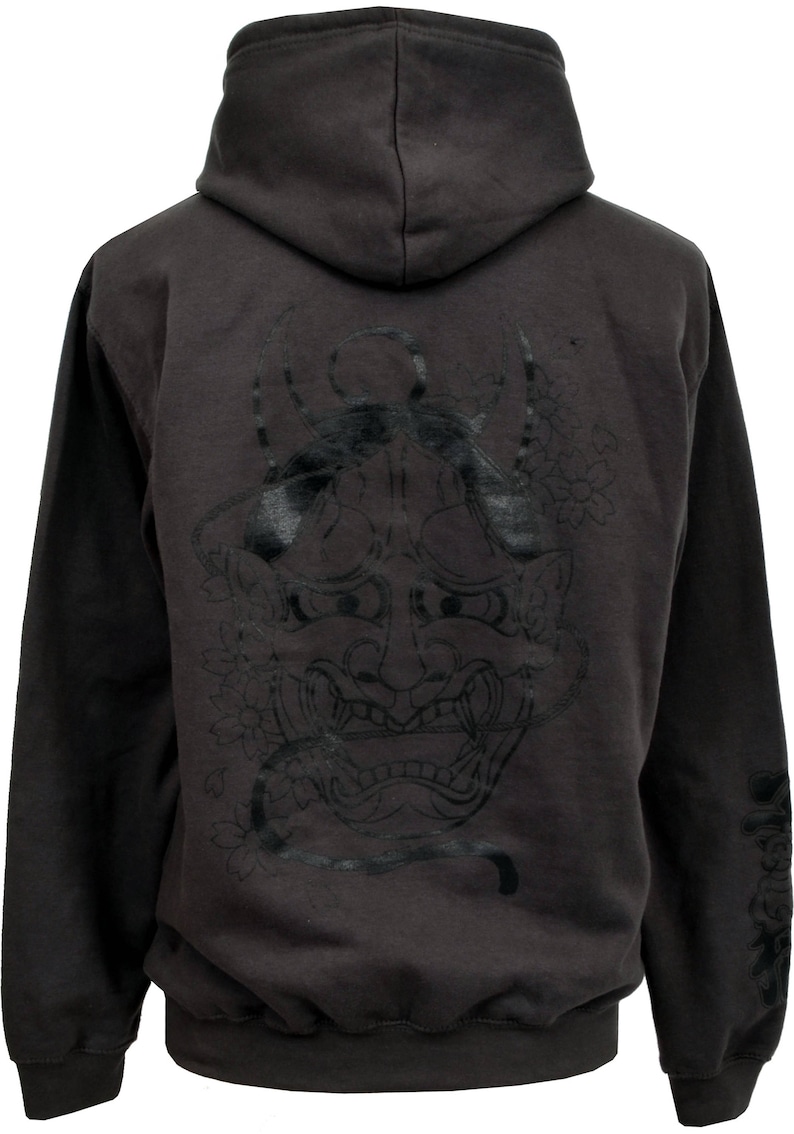 May include: A dark gray hooded sweatshirt with a black and white Japanese demon mask design on the back. The mask has a fierce expression with sharp teeth and horns.