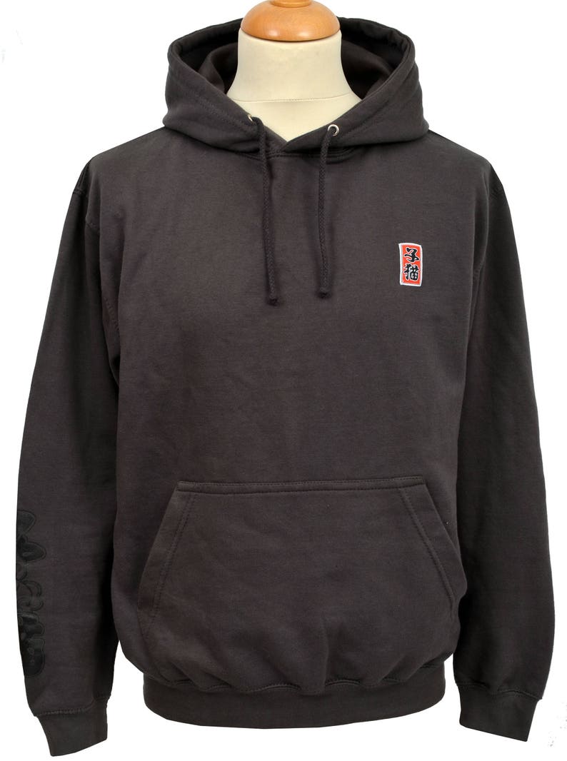 May include: A dark gray hooded sweatshirt with a small red square patch on the chest that says "三福" in black lettering. The sweatshirt has a kangaroo pocket and a drawstring hood.