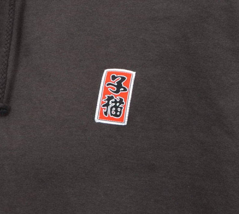May include: A dark gray hoodie with a red and white square patch featuring Japanese characters. The characters are "三福" which translates to "Three Blessings".