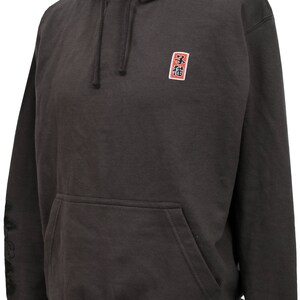 May include: A dark gray hooded sweatshirt with a small red square patch on the chest that says "福" in black kanji. The sweatshirt has a kangaroo pocket and black drawstrings.