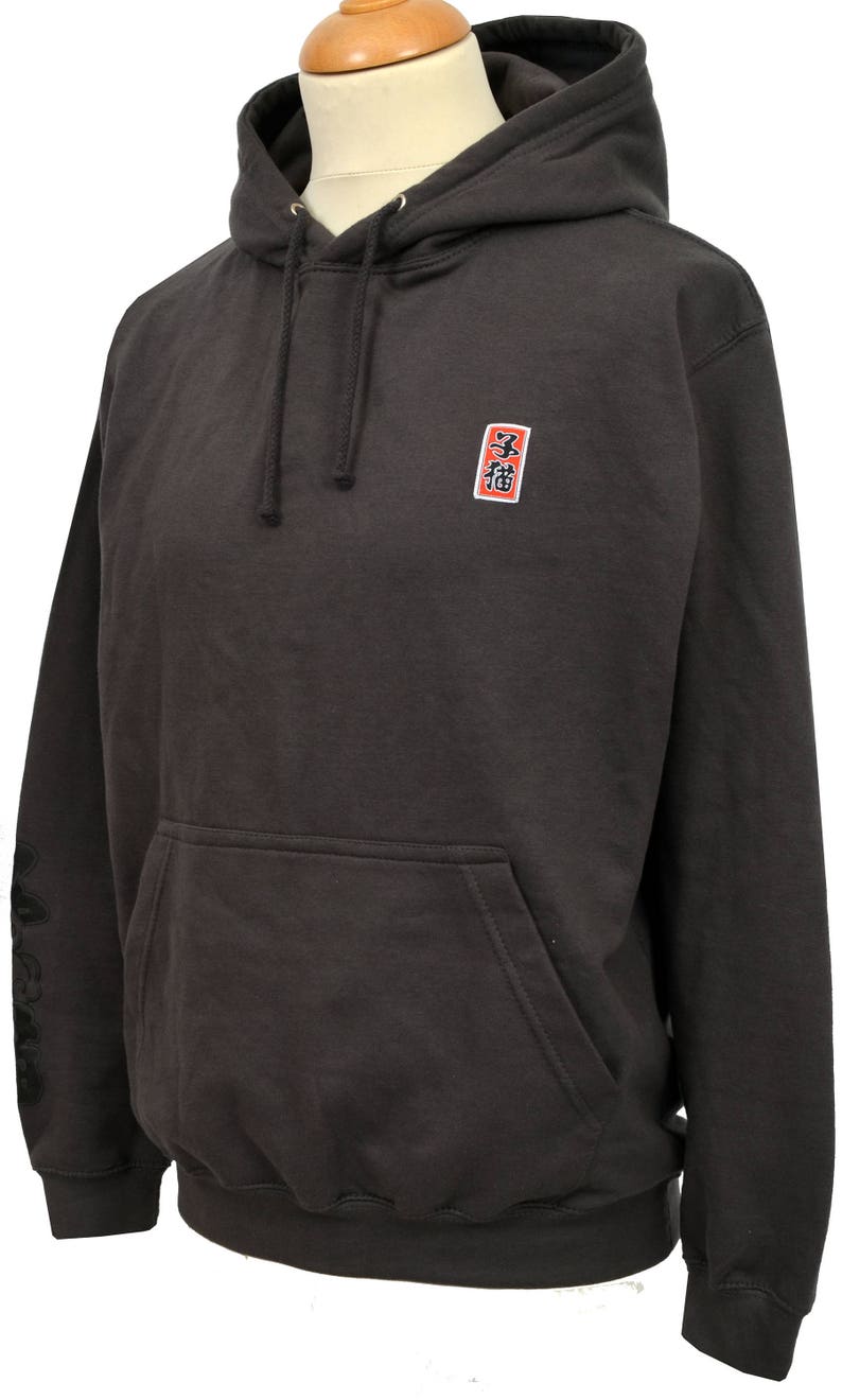 May include: A dark gray hooded sweatshirt with a small red square patch on the chest that says "福" in black kanji. The sweatshirt has a kangaroo pocket and black drawstrings.