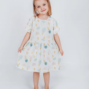 Image of girls dress sewing pattern PDF featuring short sleeve dress for kids, suitable for beginners.