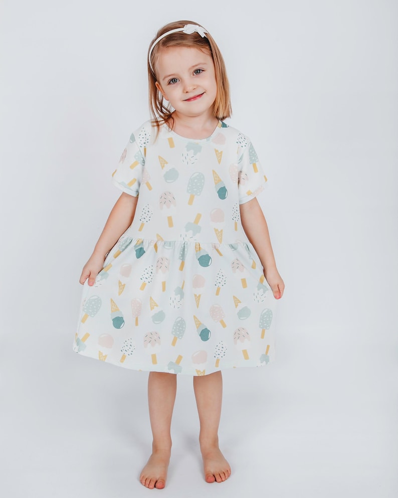 Image of girls dress sewing pattern PDF featuring short sleeve dress for kids, suitable for beginners.