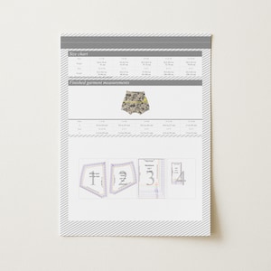 May include: A printed size chart and pattern pieces for sewing shorts. The chart includes measurements in inches. The shorts are beige with a pattern of various shapes and objects. The pattern pieces are labeled with numbers.