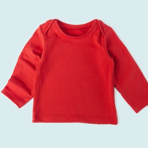 Close-up of tee neckline and stretchy hem on sewn baby tee