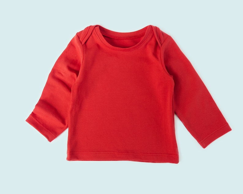 Close-up of tee neckline and stretchy hem on sewn baby tee