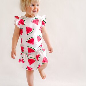Toddler wearing dropped waist dress sewn from pattern