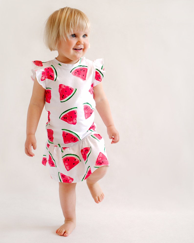 Toddler wearing dropped waist dress sewn from pattern