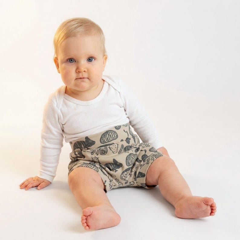 Baby wearing handmade high waisted bloomers sewn from a beginner PDF sewing pattern.