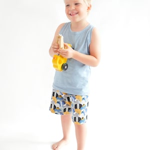Toddler boy wearing handmade tank top and shorts summer outfit sewn from a PDF sewing pattern.