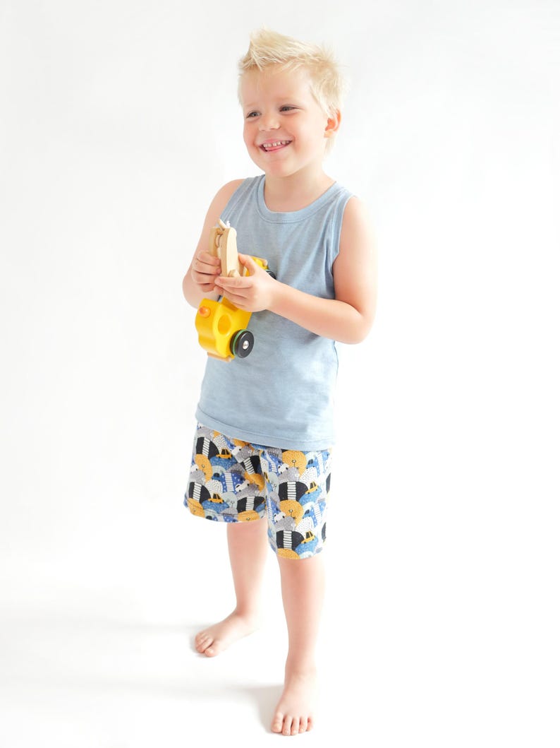 Toddler boy wearing handmade tank top and shorts summer outfit sewn from a PDF sewing pattern.