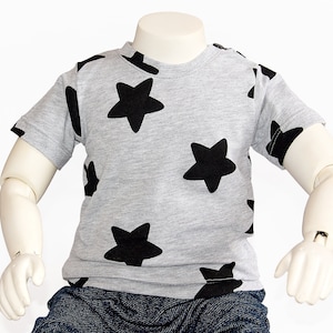 May include: A gray short-sleeved t-shirt with a black star pattern.