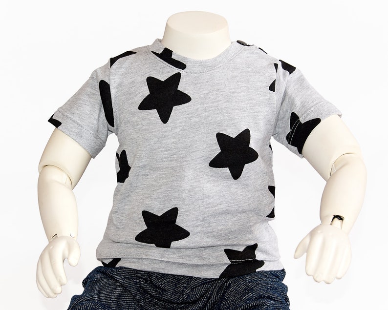 May include: A gray short-sleeved t-shirt with a black star pattern.