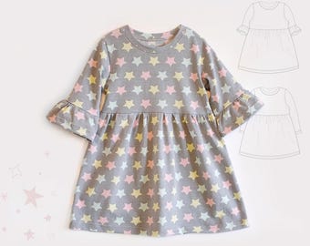 May include: A gray long-sleeve dress featuring a repeating pattern of light pink, yellow, and white stars. The dress has a round neckline, a gathered waistline, and flared bell sleeves. A black and white line drawing of the dress is included.
