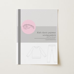 May include: A sewing pattern document for kids classic pajamas in sizes 2 to 10 years. The cover features a pink circular logo with the text MadeByMePatterns, a grey and white striped background, and a line drawing of a long-sleeve top and pants.