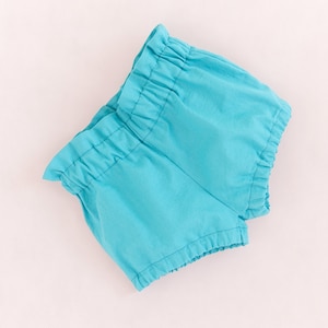 Flat lay of toddler shorts with elastic waist, made using PDF pattern