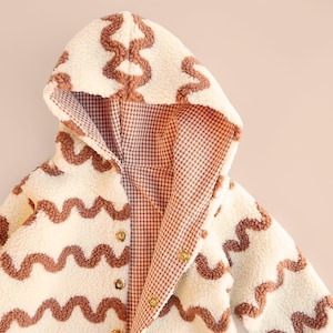 Gender neutral kids outerwear sewing project showing reversible lining and snaps.