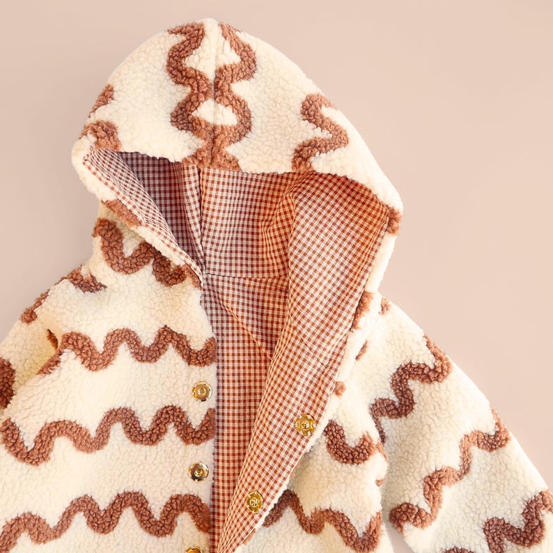 Gender neutral kids outerwear sewing project showing reversible lining and snaps.