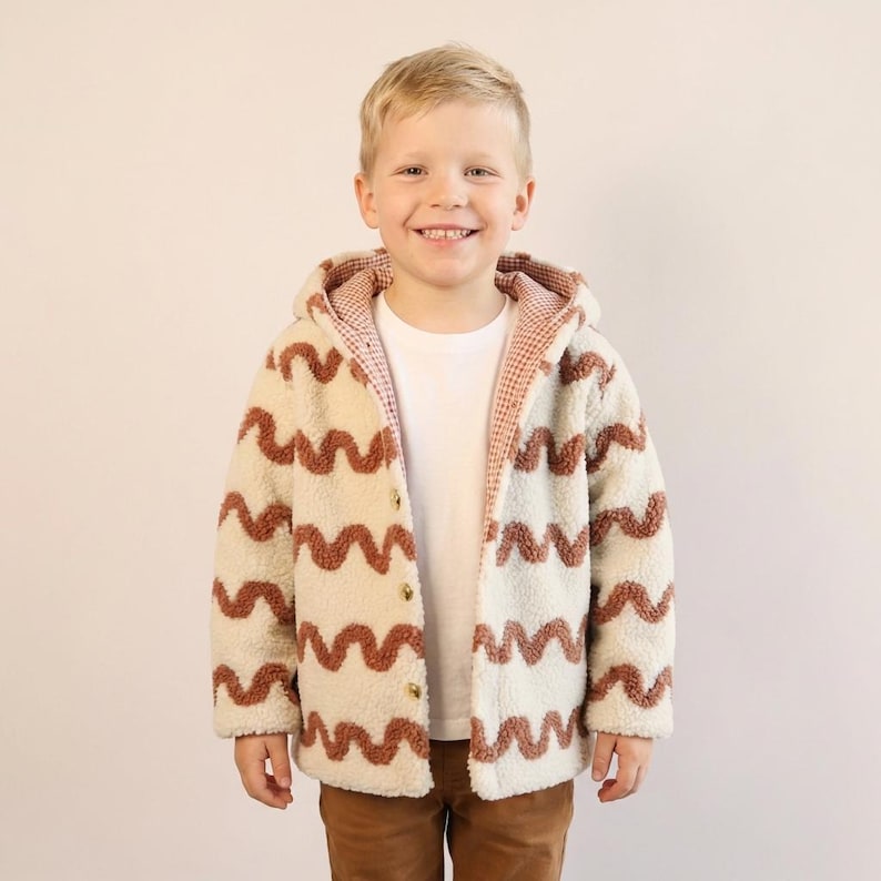 Child wearing a handmade reversible jacket sewn from a PDF kids jacket sewing pattern.
