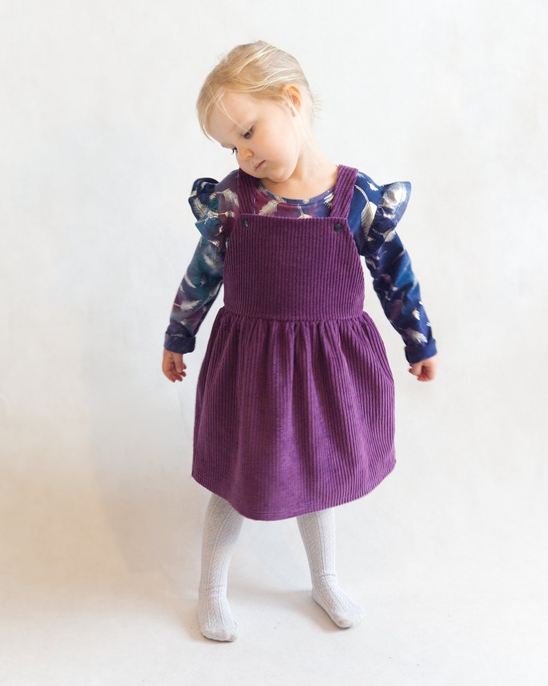 Adjustable back strap options on kids pinafore dress sewing pattern – cross-back or straight-back style.