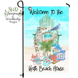 May include: A garden flag with a beach theme. The flag features an Adirondack chair, a seagull, and beach-themed decor. Text on the flag reads "Welcome to the Keith Beach House" and "Beach Please."