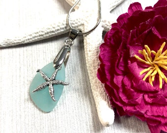 May include: A silver chain necklace with a light blue sea glass pendant and a silver starfish charm.