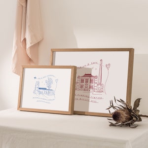 May include: Two framed illustrations of buildings with handwritten text. The top frame is in red and says "Leigh & Dan, The Pumping Station, 11th August 2023". The bottom frame is in blue and says "Mr & Mrs Kendall, Ashmall St. Irish, Suffolk, 30th July 2023".