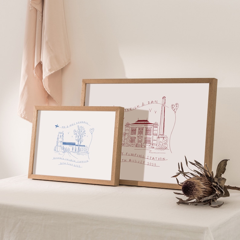 May include: Two framed illustrations of buildings with handwritten text. The top frame is in red and says "Leigh & Dan, The Pumping Station, 11th August 2023". The bottom frame is in blue and says "Mr & Mrs Kendall, Ashmall St. Irish, Suffolk, 30th July 2023".