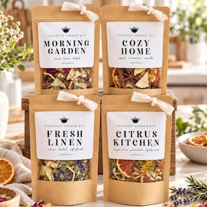 May include: Four brown kraft paper pouches labeled Stovetop Simmer Kit with white ribbons. The labels read Morning Garden, Cozy Home, Fresh Linen, and Citrus Kitchen. Each pouch has a clear window showing dried fruit, herbs, and spices inside.