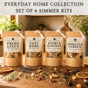 May include: Set of four simmer kits from the Everyday Home Collection. Each kit is in a brown paper pouch with a white label and a white ribbon. The labels read "Fresh Linen", "Cozy Home", "Citrus Kitchen", and "Morning Garden".