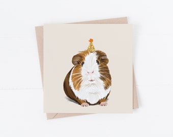 May include: A brown and white guinea pig wearing a gold glitter party hat with an orange pom-pom on top. The guinea pig is looking directly at the camera.