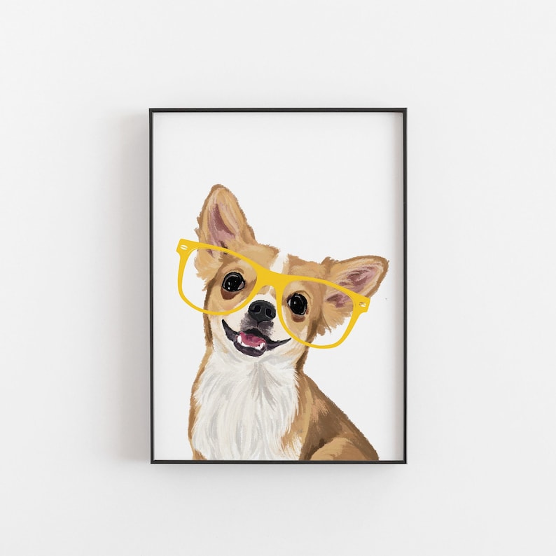 May include: Framed print of a Chihuahua wearing yellow spectacles, smiling. The dog has brown and white fur, with its tongue showing. The artwork is set against a white background, framed in black.