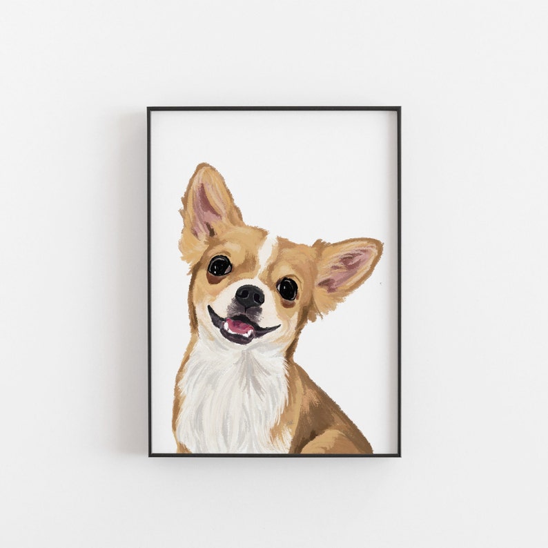 May include: Framed print of a smiling Chihuahua dog. The dog has brown and white fur, large black eyes, and a pink tongue. The artwork is set against a white background and framed in a black border.