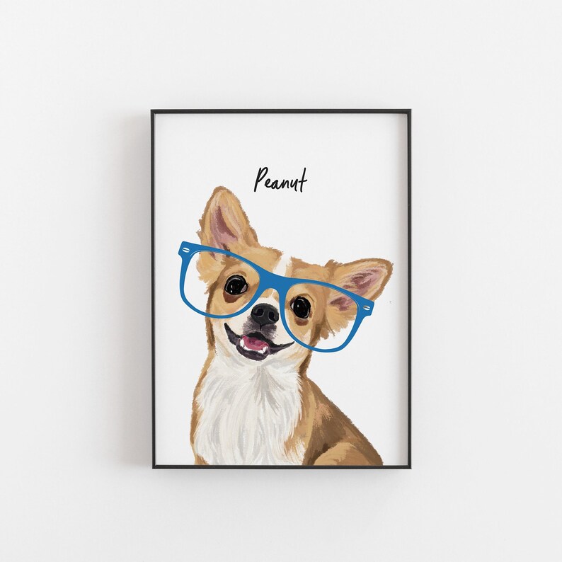 May include: Framed print of a Chihuahua wearing blue glasses, with the name "Peanut" above. The dog has brown and white fur and is smiling. The artwork is set against a white background and framed in black.