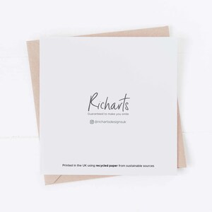 May include: A white card with the text "Richarts" in black script font. Below the text is the phrase "Guaranteed to make you smile" in smaller black font. Below that is a social media icon and the text "@richartsdesignsuk". At the bottom of the card is the text "Printed in the UK using recycled paper from sustainable sources".
