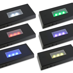 May include: Six black rectangular display bases with clear acrylic tops and three LED lights in each. The lights are white, green, red, blue, purple, and yellow.