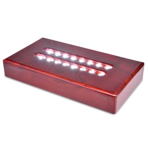 Könnte beinhalten: Ein rechteckiger Holz-Präsentationsständer mit integriertem LED-Lichtband. Der Ständer ist aus dunkelrotem Holz gefertigt und hat einen transparenten Acryleinsatz zum Ausstellen von Gegenständen. Die LED-Leuchten sind weiß und erzeugen ein helles, gleichmäßiges Leuchten.