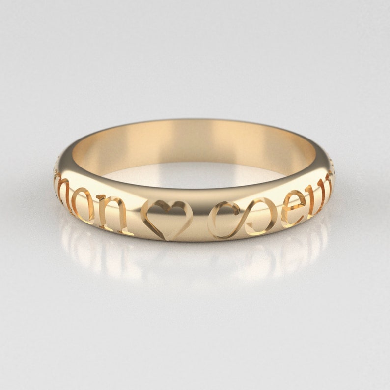 May include: A gold band ring with the words "Love" and "Forever" engraved on it, along with a heart and infinity symbol.
