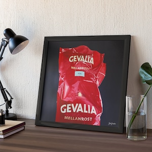 May include: A framed print of a red coffee bag with the text "GEVALIA MELLANROST KOK" and "GEVALIA MELLANROST" on it.
