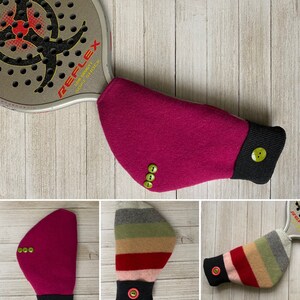 May include: Three different styles of paddle grip covers. One is a solid pink with green buttons, one is a striped pattern with a black cuff and a red button, and the last is a striped pattern with a black cuff and a green button.