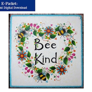 May include: A white square sign with a heart-shaped wreath of colorful flowers and leaves.  Two bumblebees are on the wreath. The sign says "Bee Kind" in black lettering.