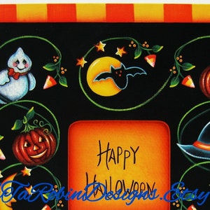 May include: A black and orange Halloween-themed picture frame with a white ghost, a bat, pumpkins, and a witch's hat. The frame has a space for a photo and says "Happy Halloween".