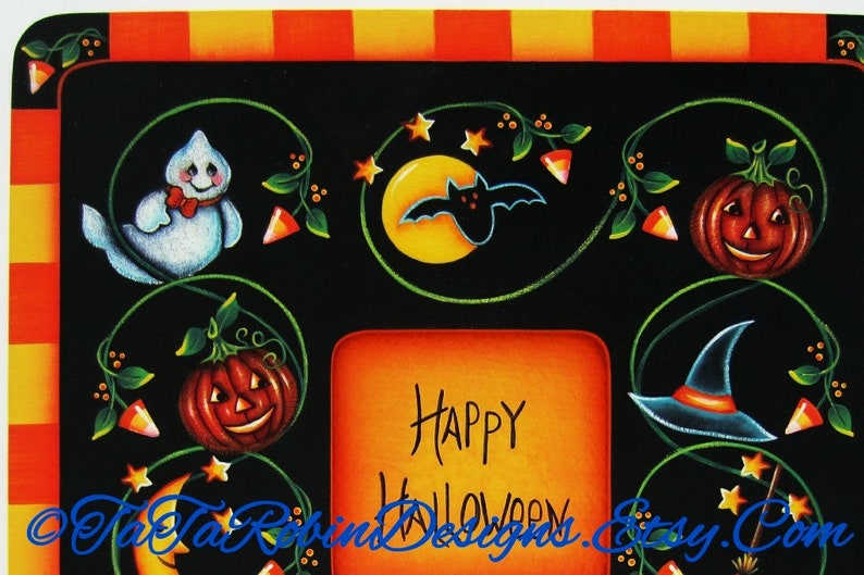 May include: A black and orange Halloween-themed picture frame with a white ghost, a bat, pumpkins, and a witch's hat. The frame has a space for a photo and says "Happy Halloween".