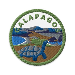 May include: Green embroidered patch with the text "GALAPAGOS" in white. The patch features a blue and gray tortoise on a brown background with a blue ocean and green hills in the background.