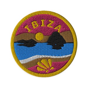 May include: A round, yellow-bordered patch with a pink, brown, and blue scene of a sunset over the ocean with a seashell in the foreground. The text "IBIZA" is embroidered in yellow on the pink background.