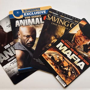 May include: Four DVD cases featuring action movies with the actors Ving Rhames and Pam Grier. The titles are "Animal", "Saving Grace", "Mafia", and "Animal".
