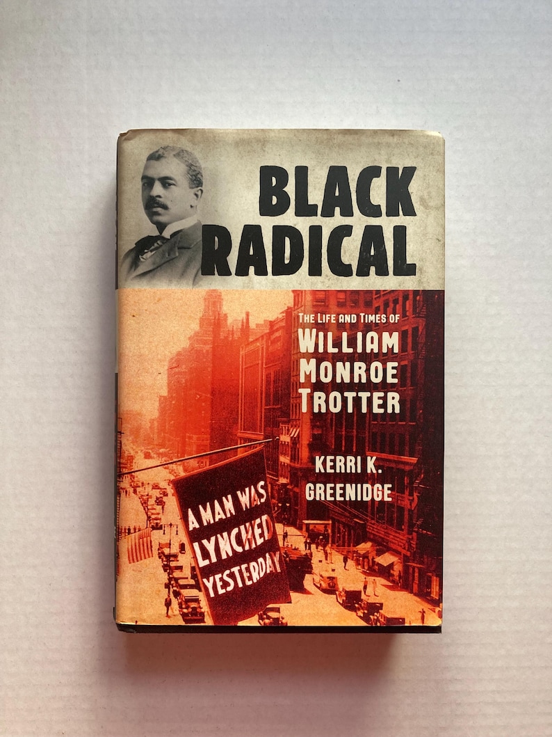 May include: A book cover with a red, white and black colour scheme. The title is "Black Radical" and the subtitle is "The Life and Times of William Monroe Trotter". The cover features a black and white photo of a man in a suit and tie. The background is a city street scene with a sign that reads "A man was lynched yesterday".