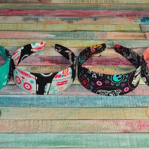 May include: Four colorful headbands with different patterns. The headbands are made of fabric and have a wide, comfortable fit.